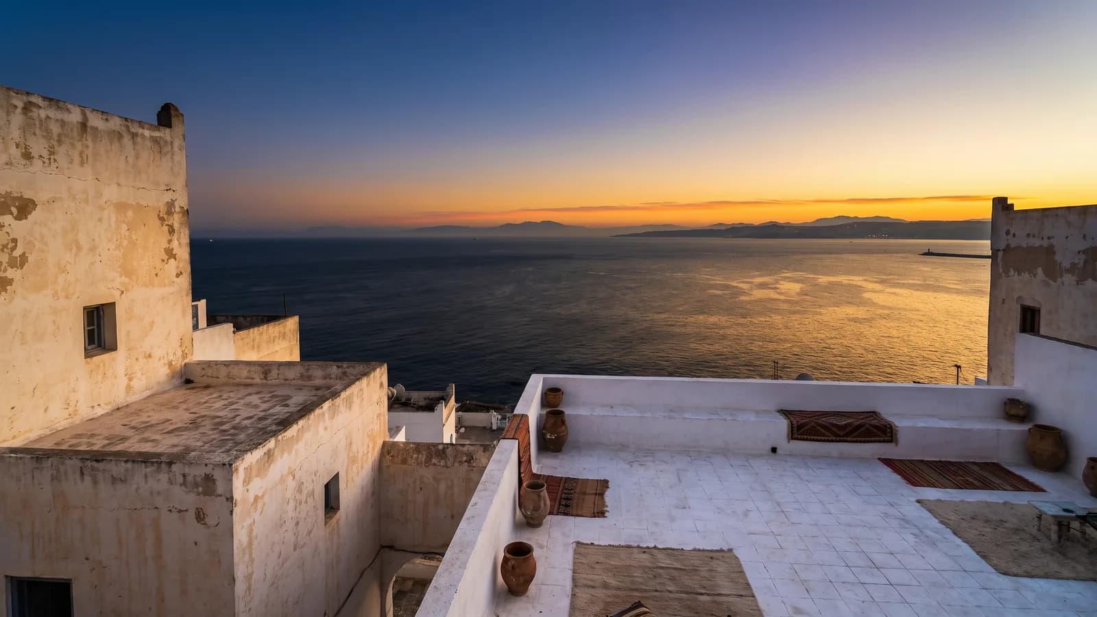 Vue sur le détroit de Gibraltar depuis une terrasse blanchie à la chaux de Tanger, au crépuscule